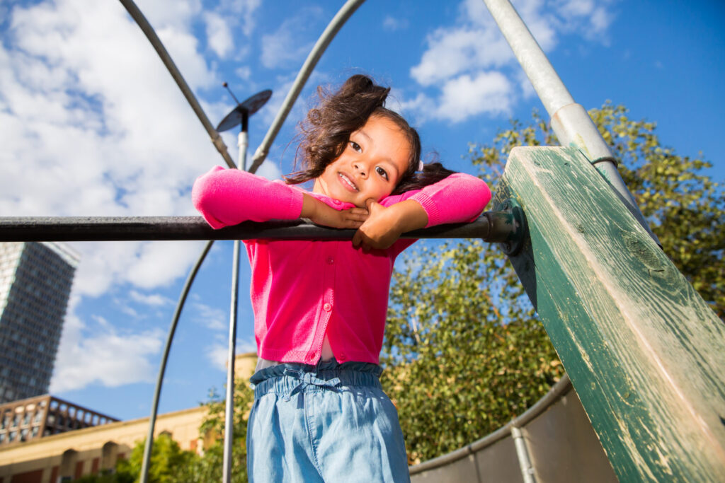 Young girl outside smiling at camera