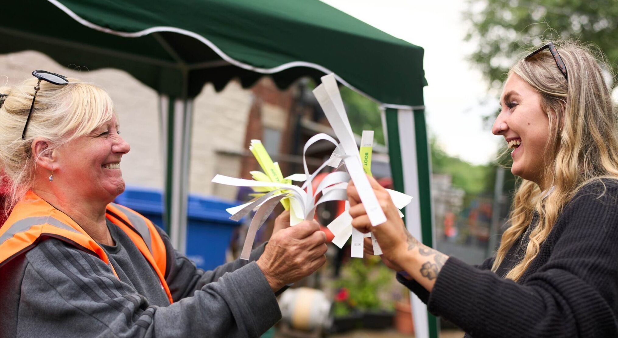 People talking at an outdoor community event.