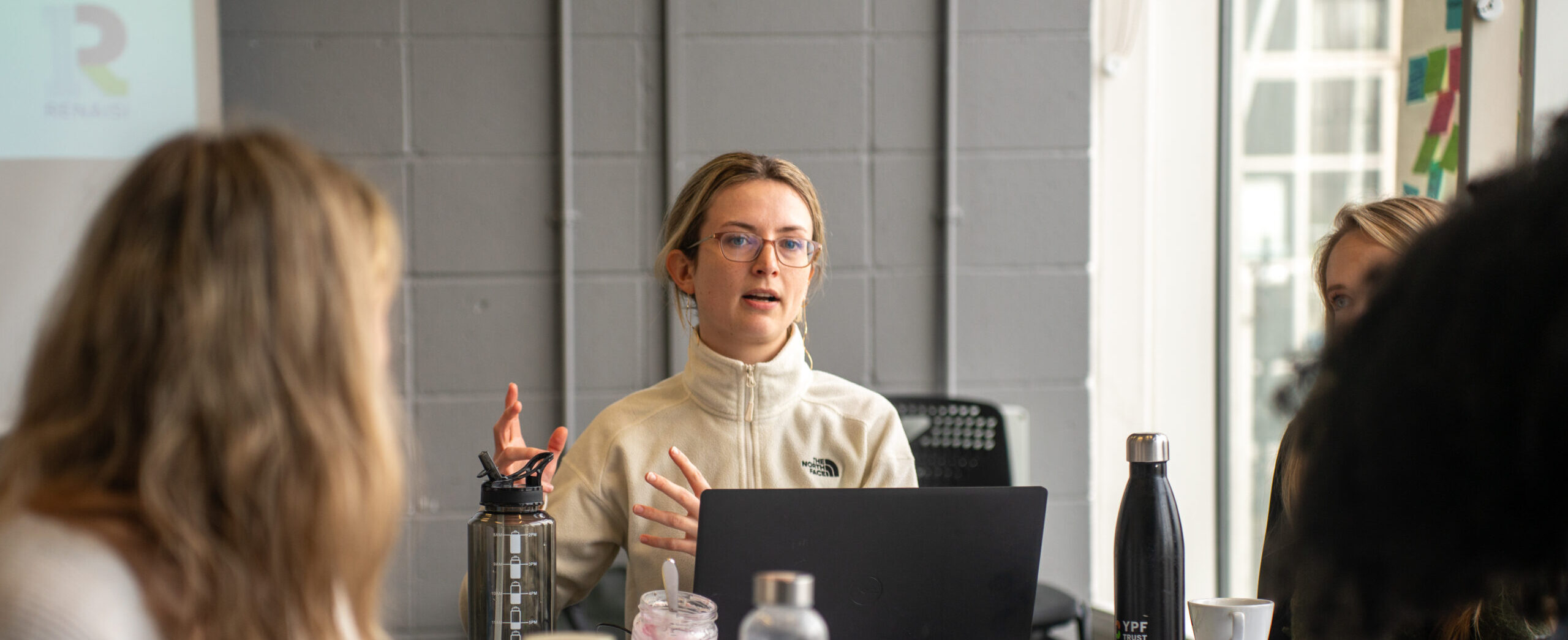 A participant speaking during a workshop around a table.