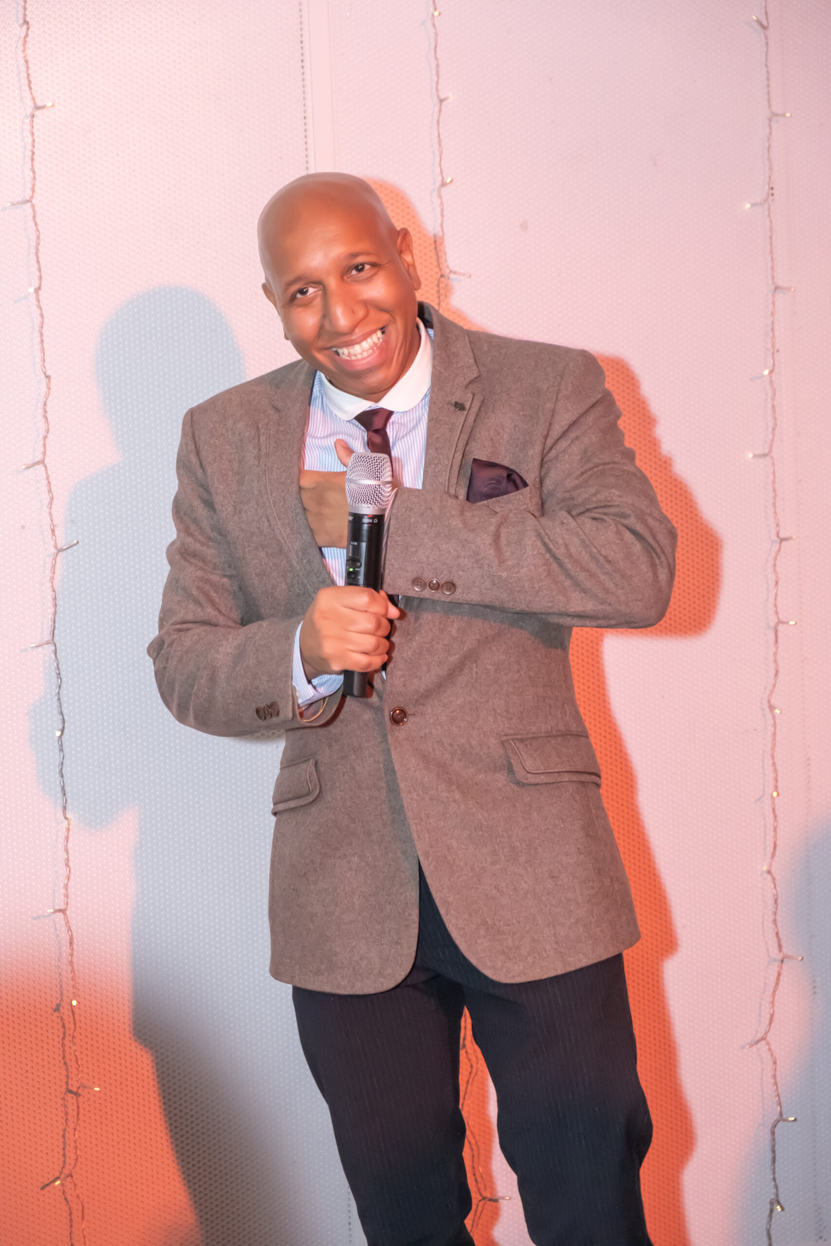 A speaker addressing an audience with a microphone.