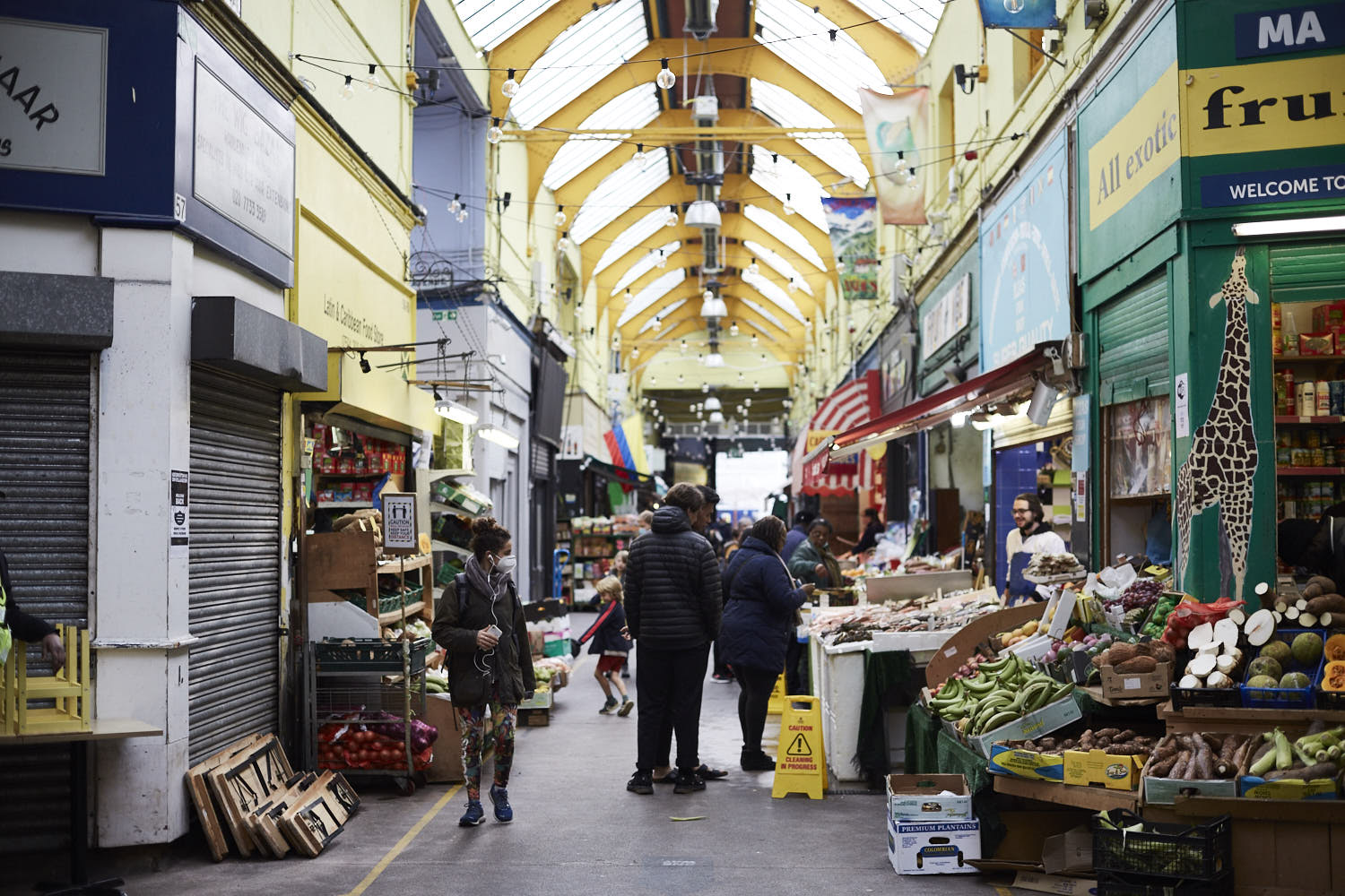 People walking through a covered market.
