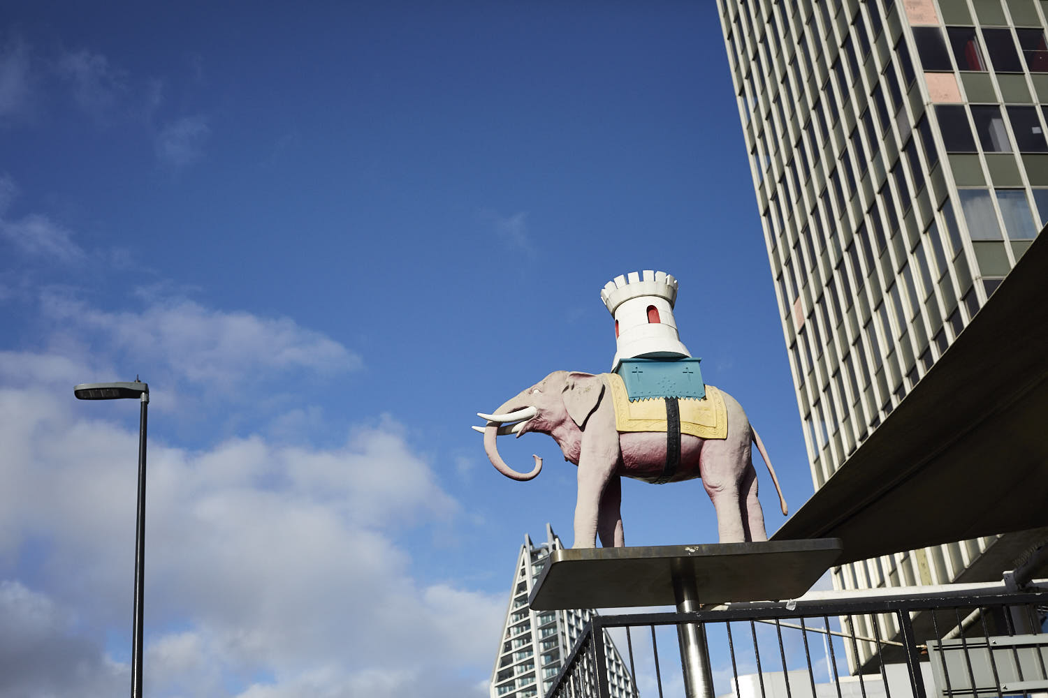 Colourful public artwork beside a city building.