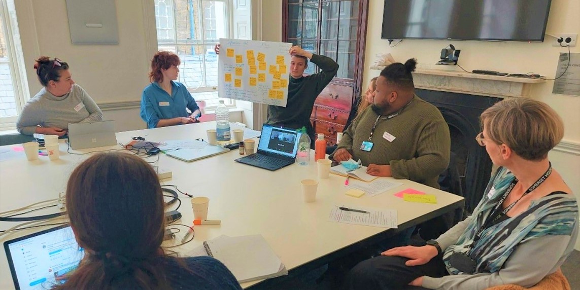 Participants discussing ideas together around a table.