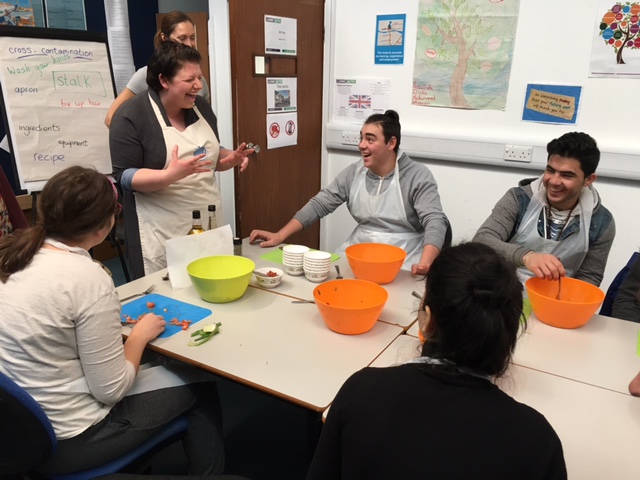 Participants taking part in a community activity around a table.