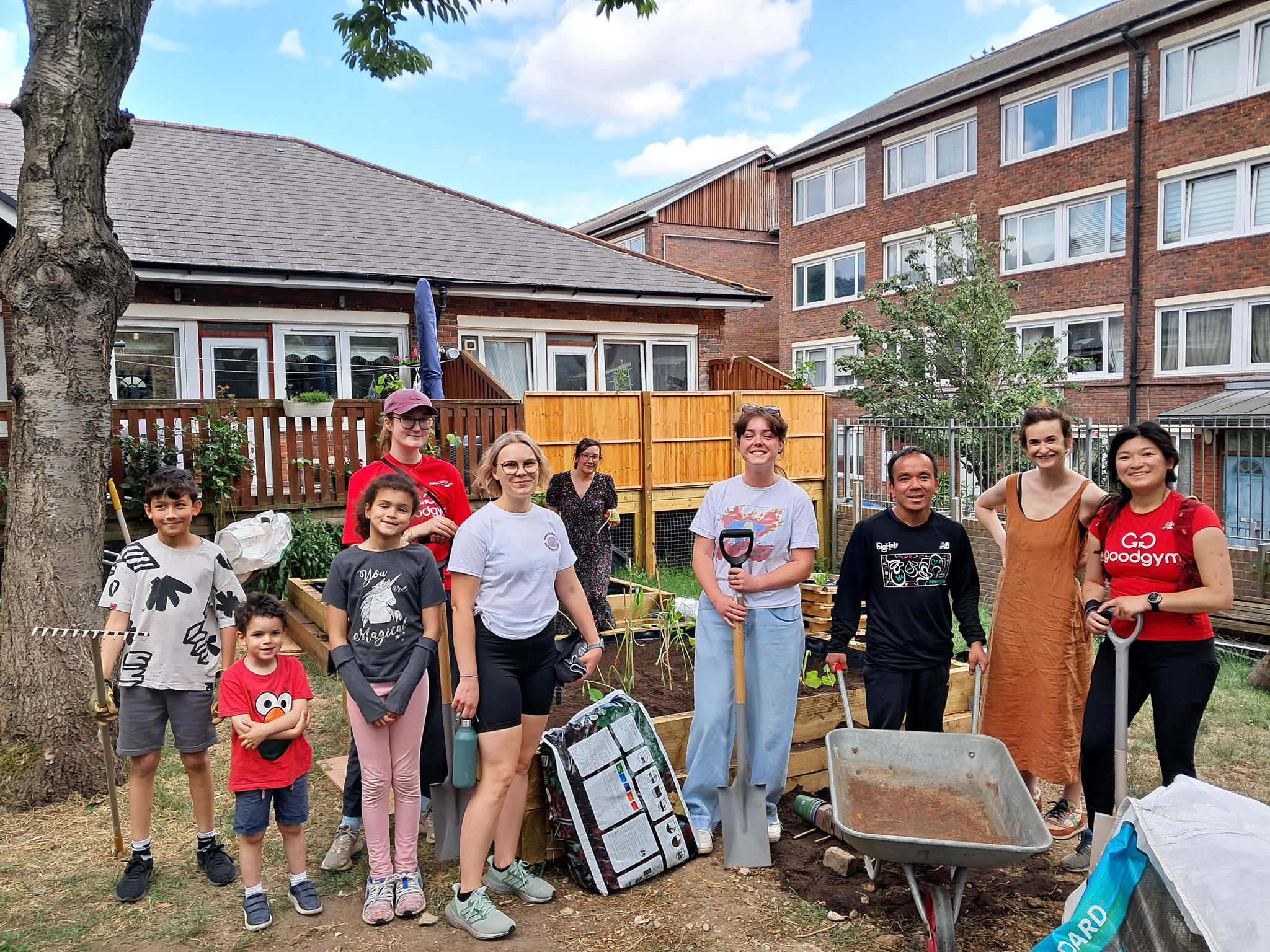 Community members and volunteers working together in a Peabody community garden.